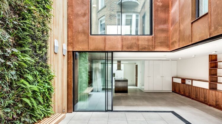 minimal windows corner opening slim sliding glass doors below a juliet balcony with sliding glass doors in a luxury residential development
