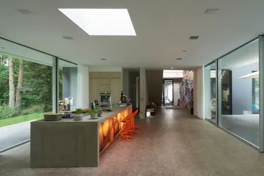 contemporary kitchen design with minimal windows sliding glass doors and an automated venting rooflight for ventilation and natural light