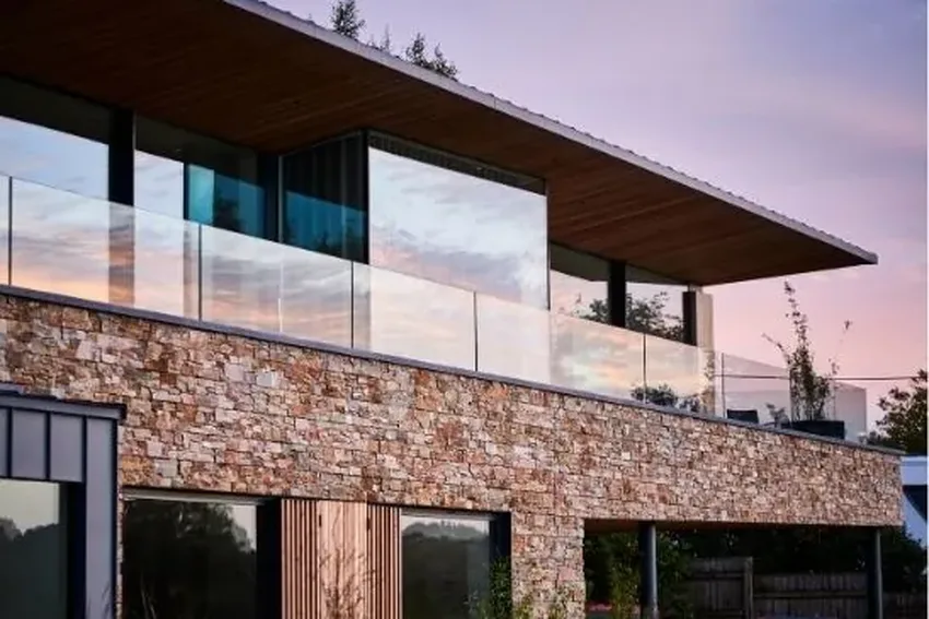 floor to ceiling sliding glass doors and a balcony with a frameless glass balustrade