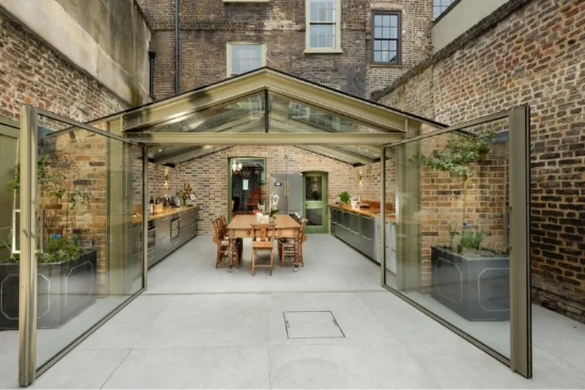 glass extension with double opening aluminum pivot doors from minimal windows