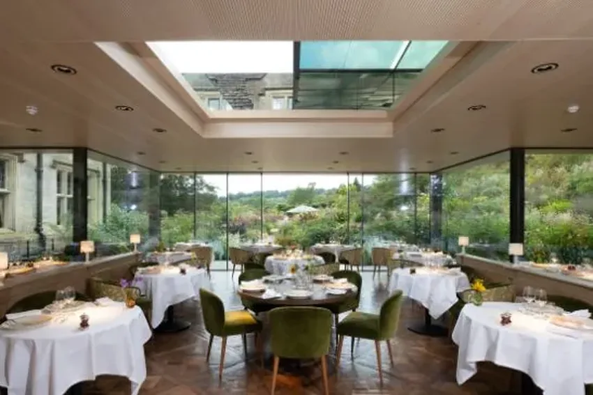 grade one listed hotel with modern restaurant extension featuring minimal windows sliding door and an automated sliding rooflight