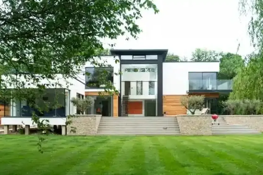 huge luxury new build home in the countryside with a double height vertical sash window and large garden