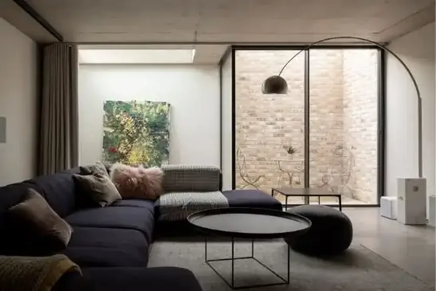 luxury basement renovation with an internal glass courtyard encased with minimal windows sliding glass doors