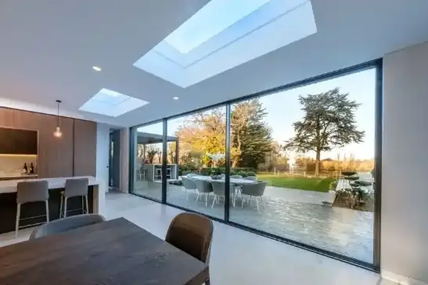 luxury new build home with minimal windows sliding glass patio doors and two automated venting rooflights for kitchen ventilation