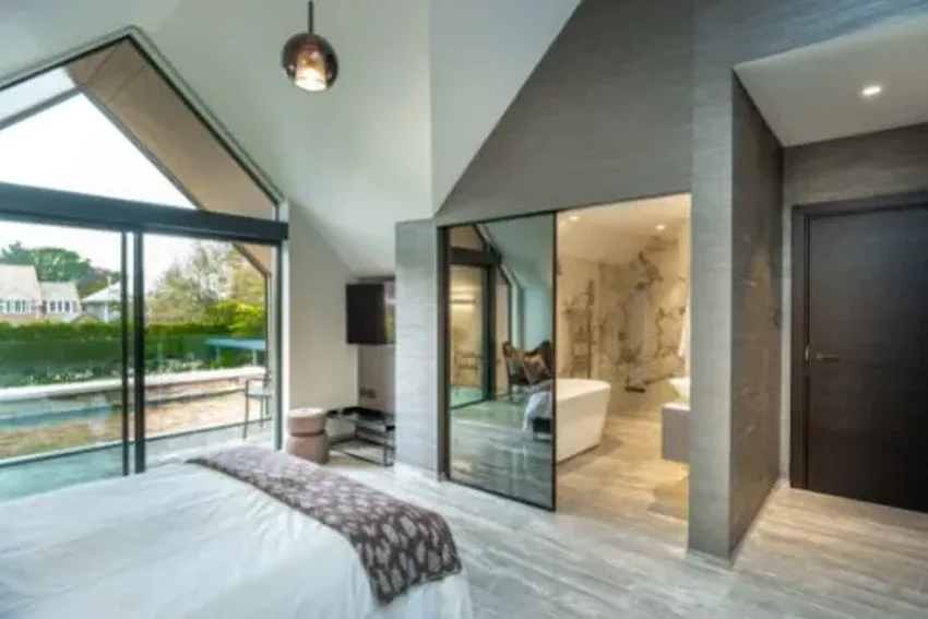 modern bedroom design with minimal windows slim sliding balcony doors and internal sliding glass doors in a bespoke glazing package for a luxury new build home