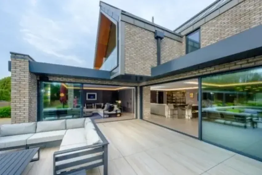 new build home in Dorset with sliding glass doors with solar control glass and a marine-grade frame finish