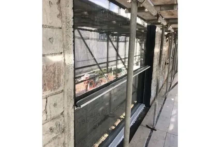 single storey two pane vertical sliding sash window that opens to create a balcony