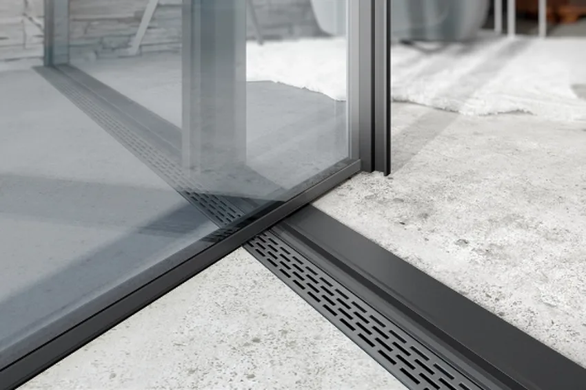 slot drain and a flush threshold on a minimal windows aluminium pivot door