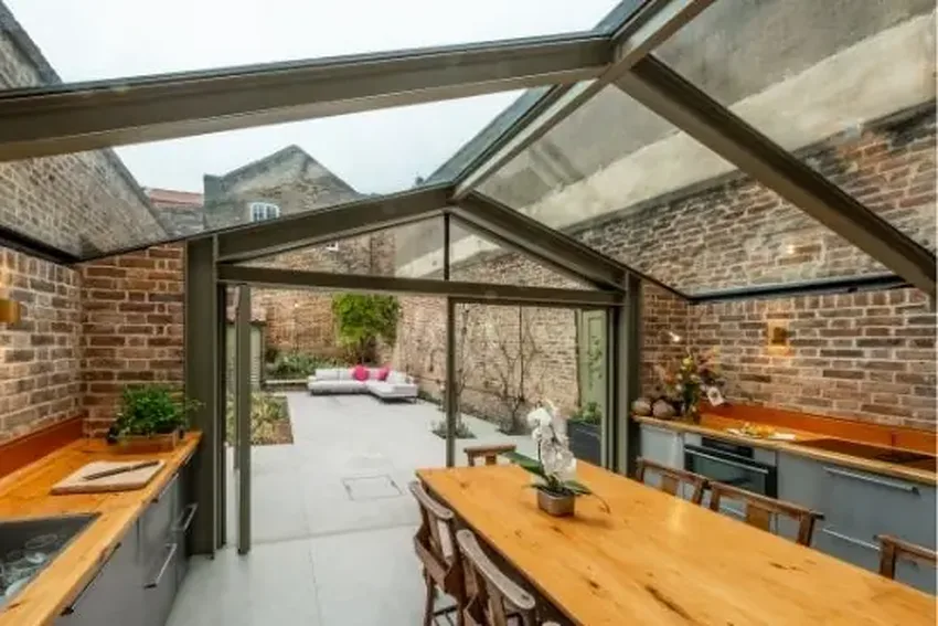thermally broken pivot door in a traditional house rear kitchen extension in London