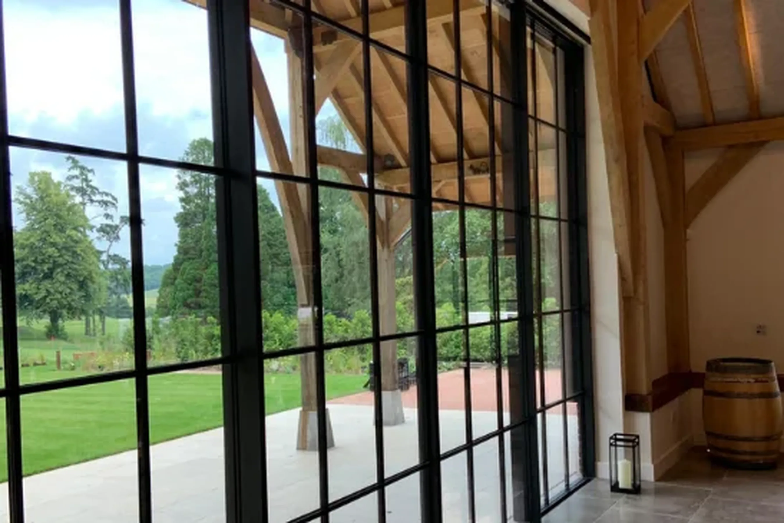 oversized aluminium sliding doors with glazing bars for a steel look design