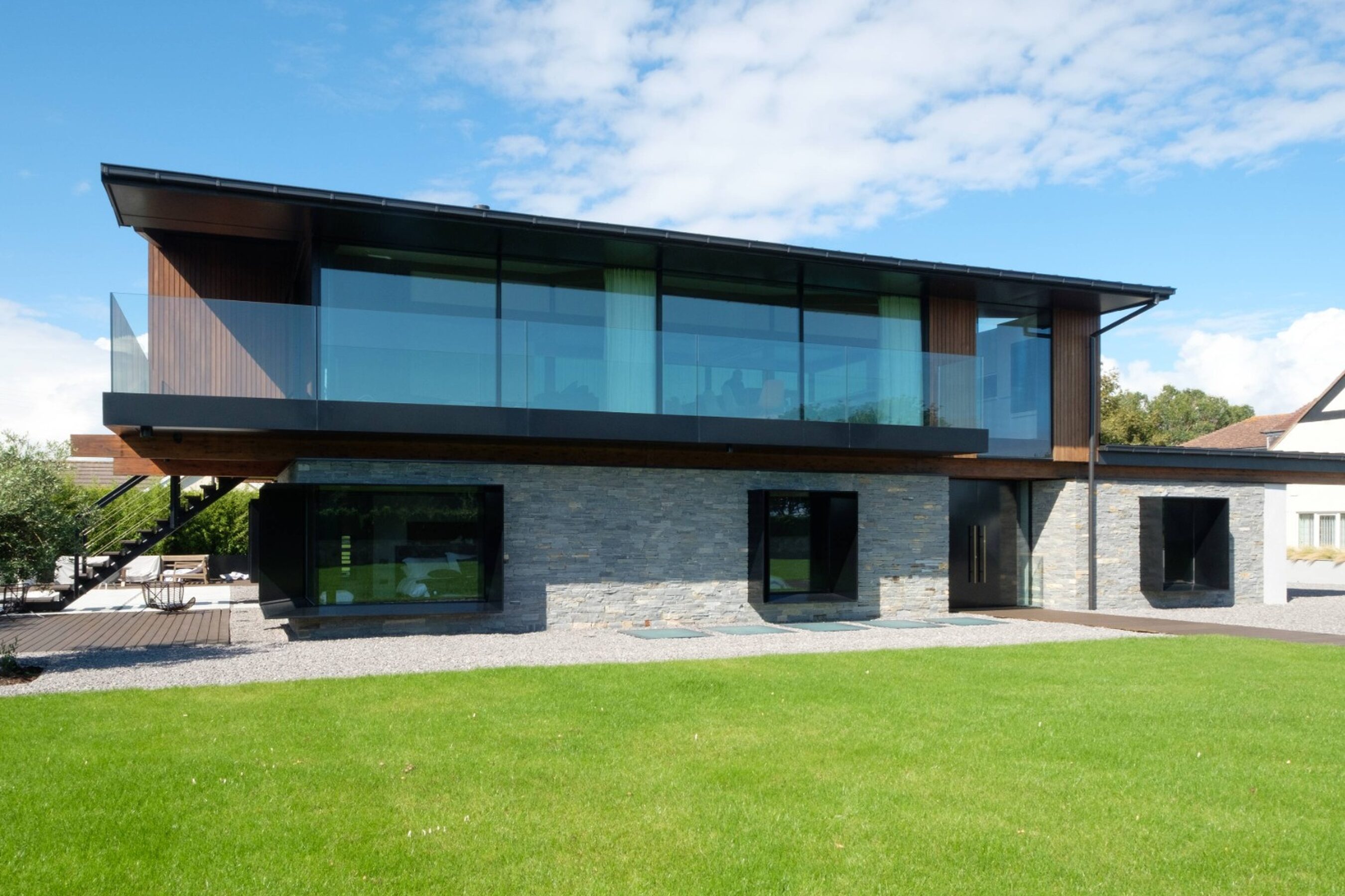 Garden view of glass sliding doors in Wales | Silver House