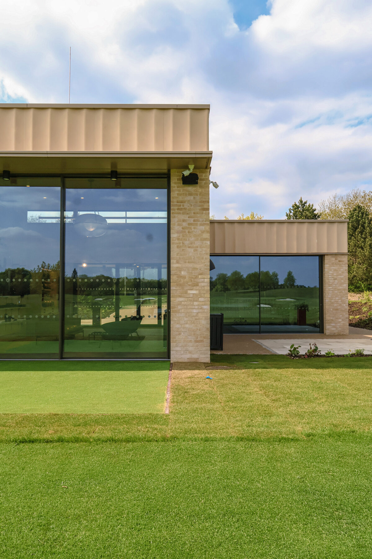 The Kingdom at the Grove - minimal windows - Large sliding glass doors for sports architecture